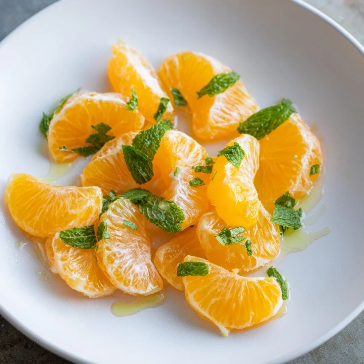 A beautiful, refreshing winter fruit salad with clementines and mint—a light, sweet treat.