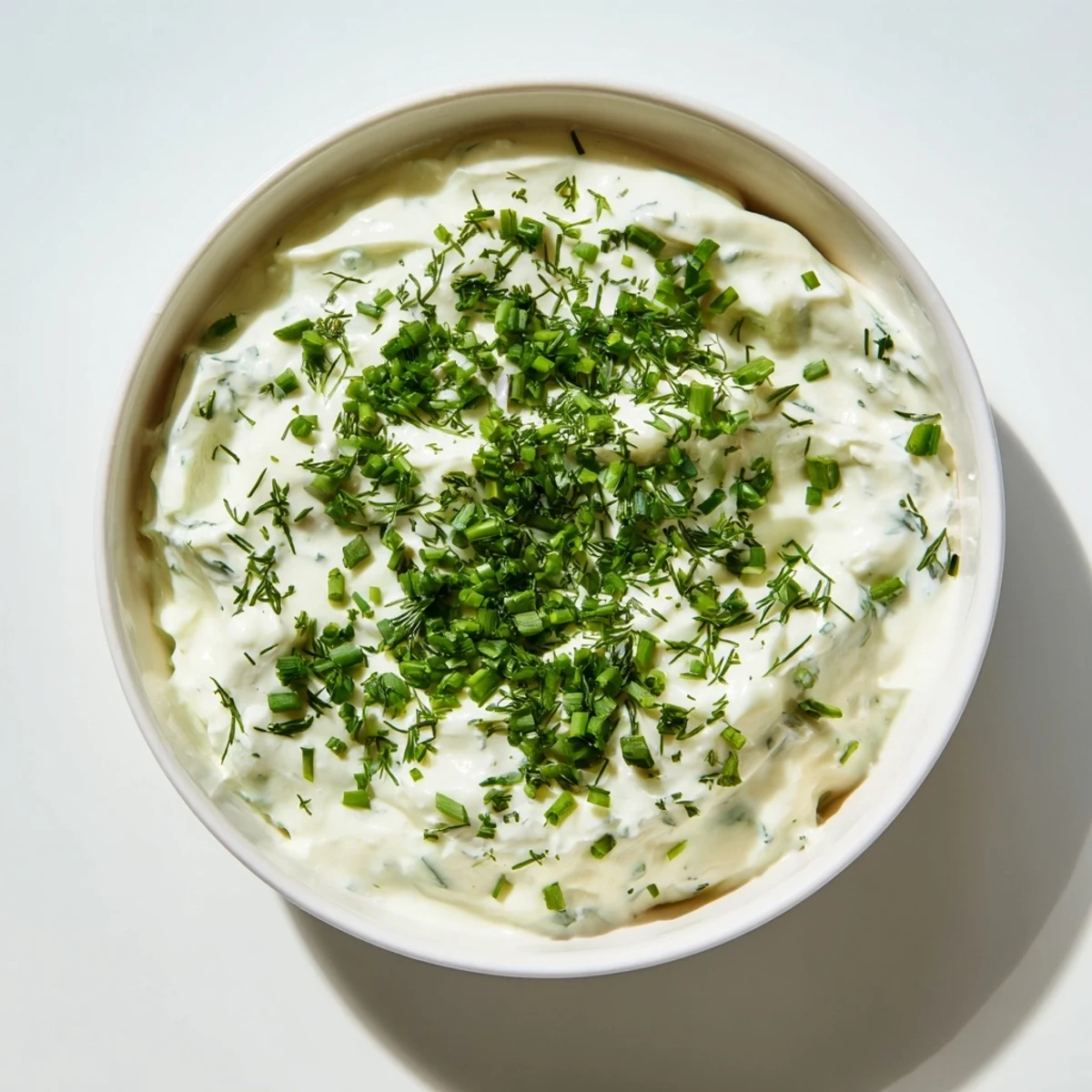 Freshly made Veggie Ranch Dip boasting a medley of herbs, ready for dipping on a platter.