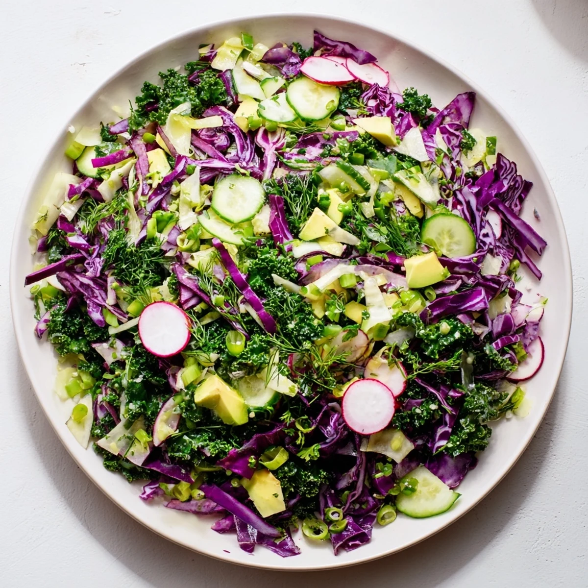Close-up of a refreshing Green Goddess Detox Cabbage Salad with crisp veggies and a tangy lemon dressing.