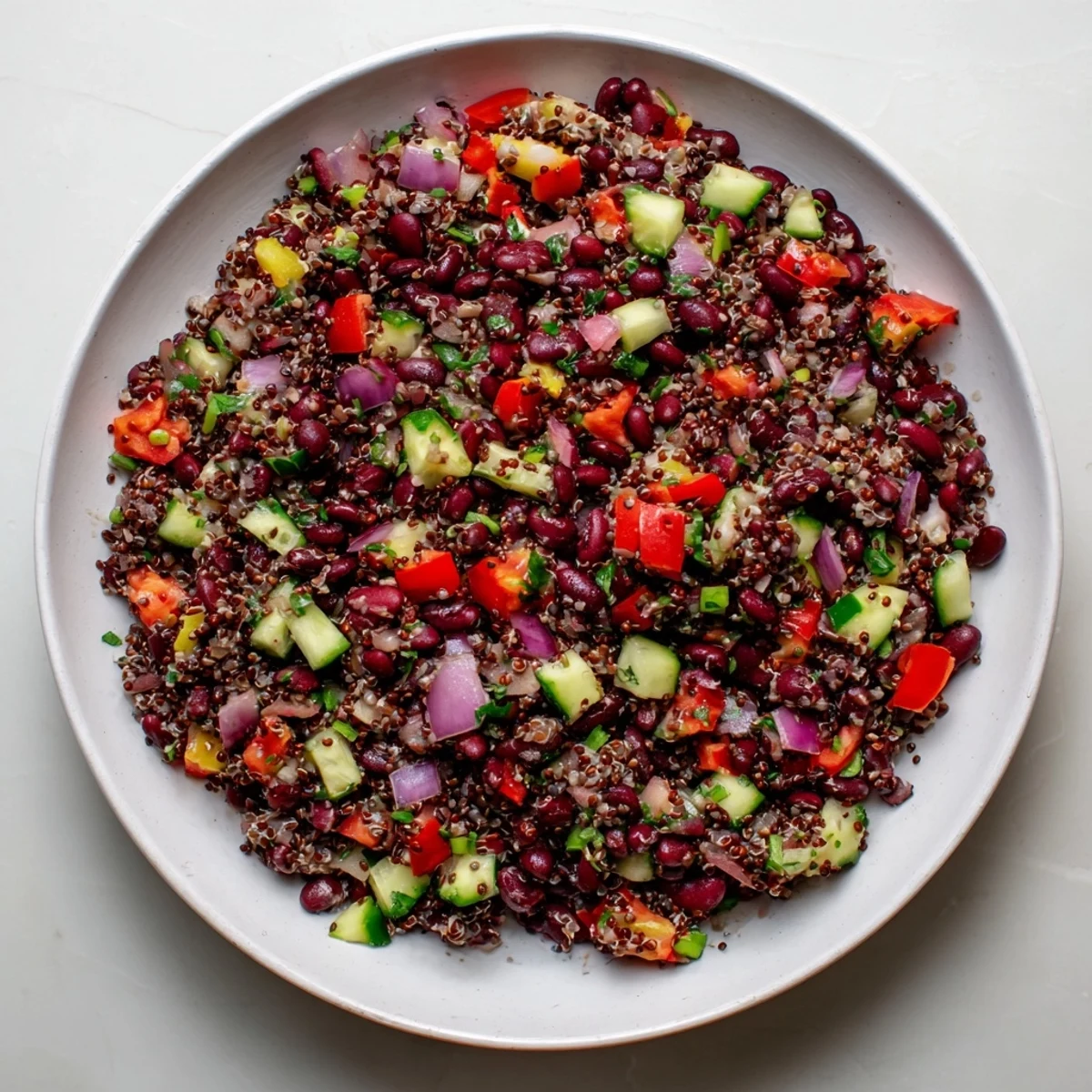 Enjoy a refreshing scoop of this flavorful Dense Bean Salad with Wellness Seeds for a healthy lunch or side offering.