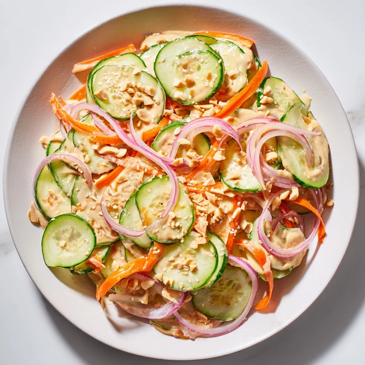 Creamy peanut dressing coats the fresh vegetables in this delicious Thai-Style Peanut Cucumber Salad.