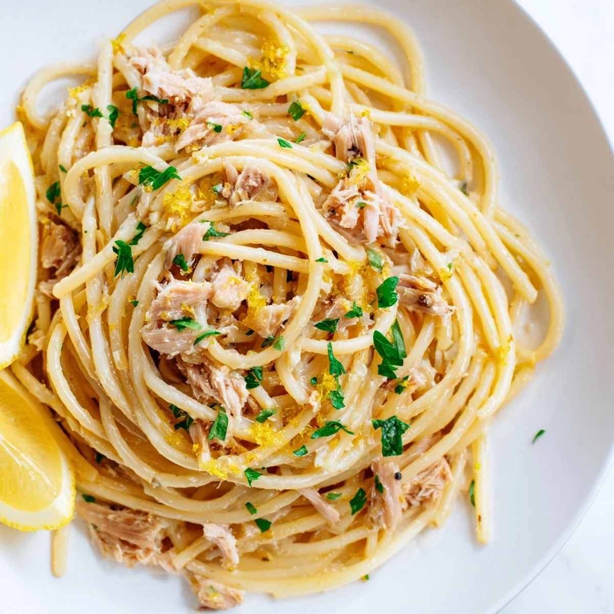 Golden, twirled Lemon-Garlic Tuna Spaghetti, a simple pasta dish with bright lemon and flaky tuna.