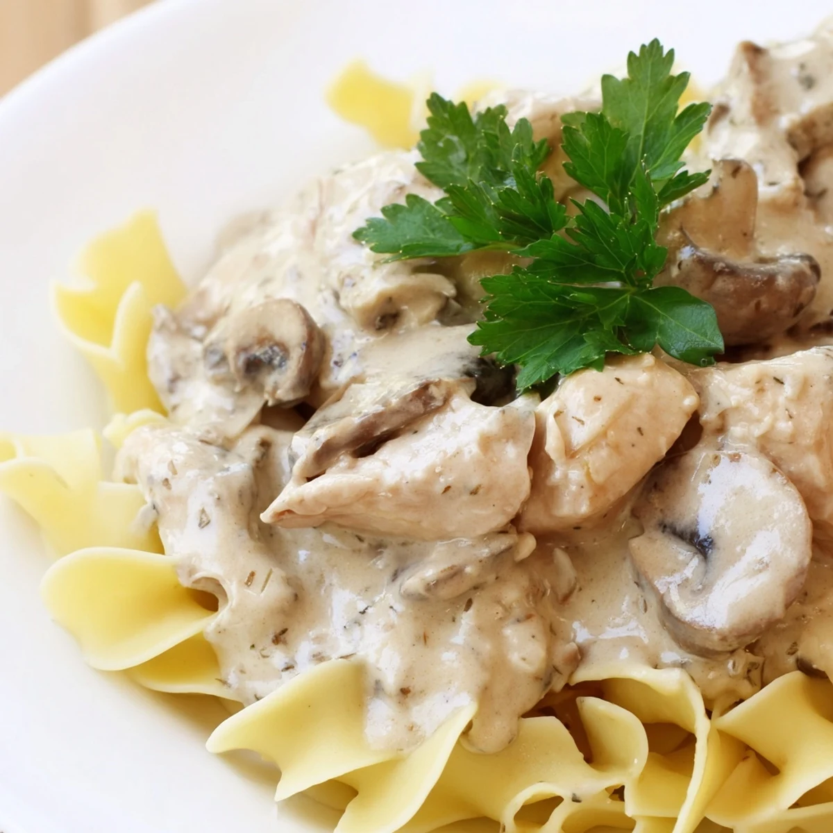 Golden-brown chicken strips and sliced cremini mushrooms simmer in a creamy, paprika-spiced stroganoff sauce over buttery egg noodles.