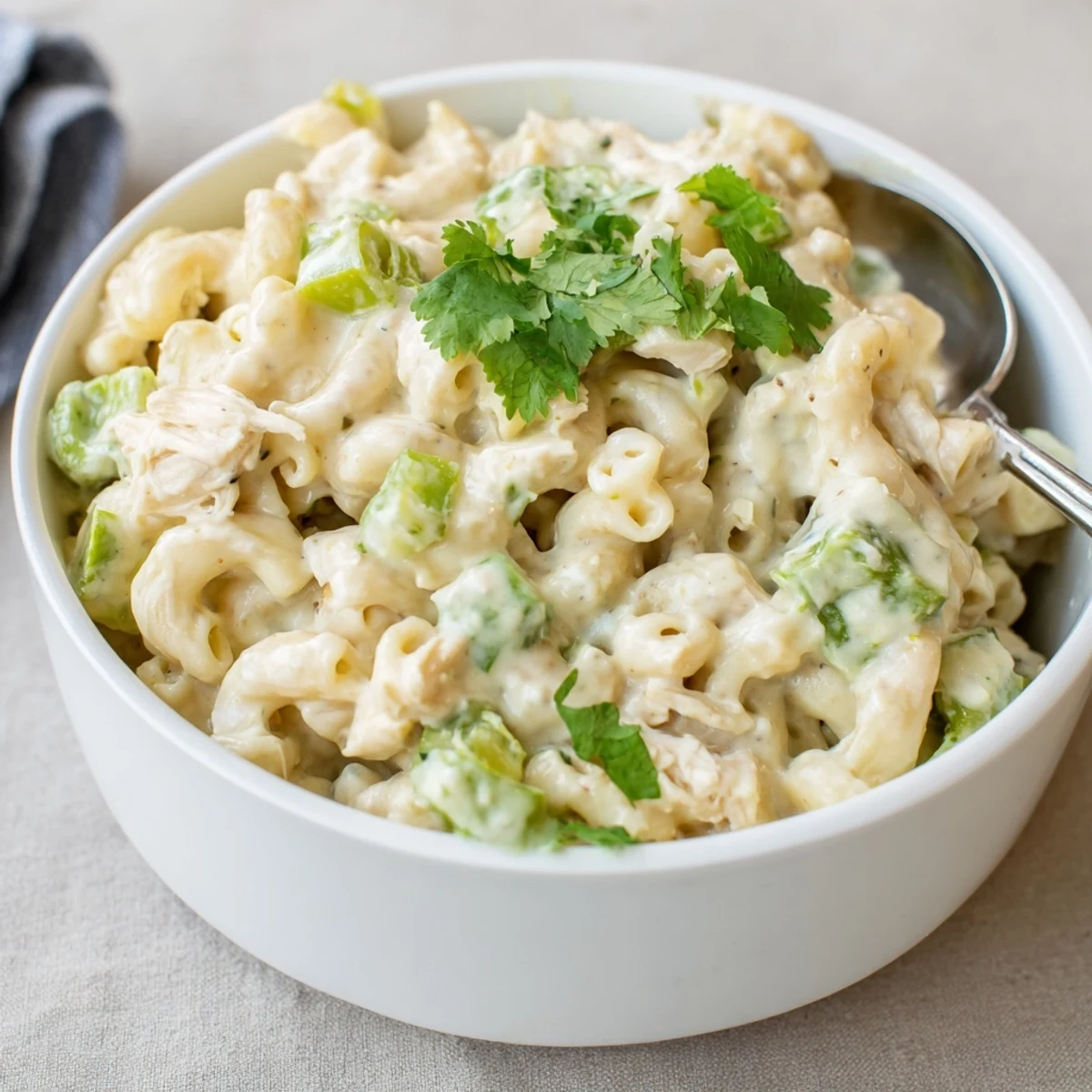 An overhead view of Green Chili Chicken Mac, showing the golden cheese crust and specks of mild green chiles.