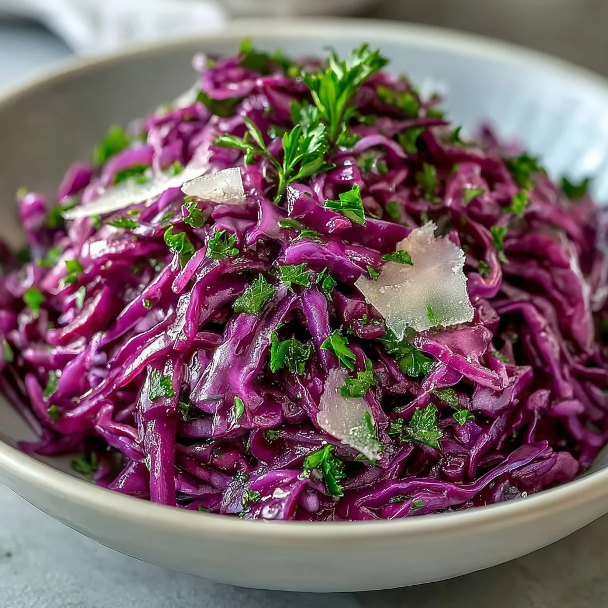 Bright red cabbage, crisp apple slices, and shaved Parmesan in a tangy vinaigrette make this Red Cabbage Coleslaw With Apple and Parmesan a refreshing, crunchy side dish.