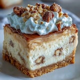 Freshly sliced Nutter Butter Cheesecake on a cake stand, featuring a rich peanut butter swirl and a crumbly cookie crust.