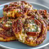 Warm, cheesy Pizza Pinwheels baked to golden perfection, with savory pepperoni and Italian herbs in every bite.  