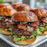 Juicy Father's Day grilled bacon burger sliders bursting with melted cheese on toasted buns.