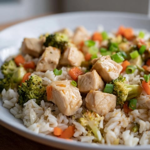 Garnished with sesame seeds and green onions, this One Pan Honey Garlic Chicken Broccoli Rice features tender chicken and crisp broccoli florets over fluffy white rice.