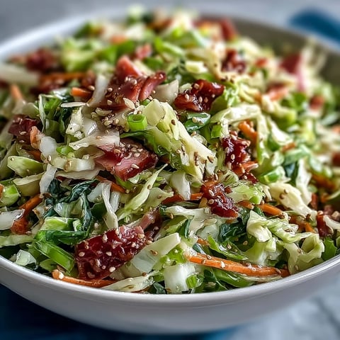 Fork-tender shredded ham and crisp green and red cabbage tossed in a tangy apple cider vinaigrette for an authentic German-style slaw.