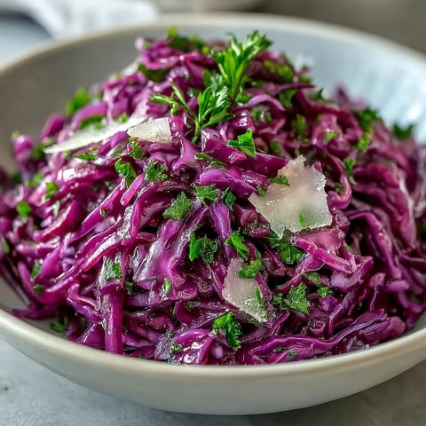 Bright red cabbage, crisp apple slices, and shaved Parmesan in a tangy vinaigrette make this Red Cabbage Coleslaw With Apple and Parmesan a refreshing, crunchy side dish.