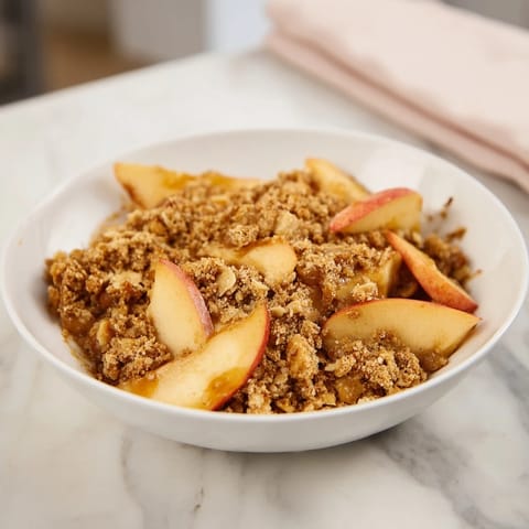 Warm Rustic Apple and Cinnamon Crumble, bubbling with sweet apples and a crispy, cinnamon crumble topping.