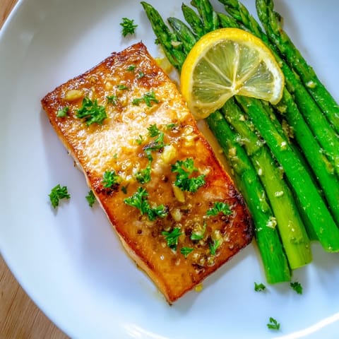 Golden, flaky skillet lemon-butter salmon with asparagus served for a delicious and easy weeknight dinner.