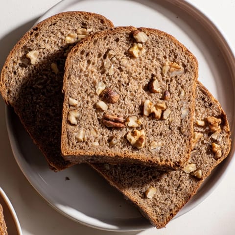 Golden crust of fresh-baked Nutty Whole Wheat Loaf Bread, perfect for sandwiches with delightful texture.