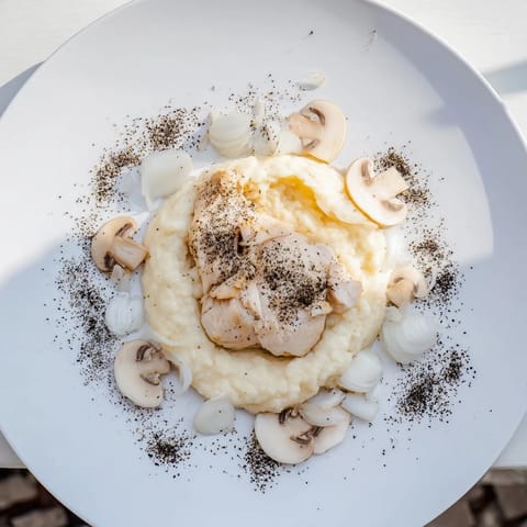 The Ghostly Gala entree: a white feast featuring poached chicken, mushrooms, and elegant purée.