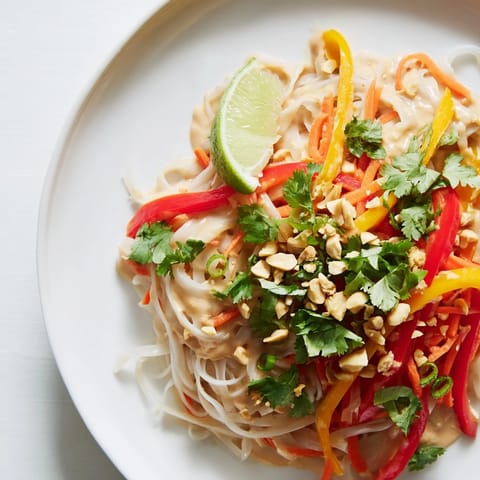 Close-up of vibrant Spicy Peanut Noodles, garnished with peanuts and cilantro, offering a burst of flavor.