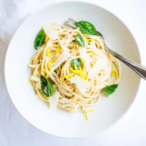 Savory Lemon Ricotta Pasta served in a white bowl, topped with lemon zest, black pepper, and a drizzle of olive oil.