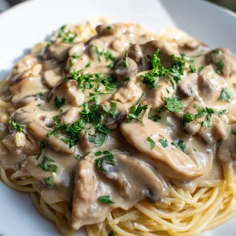 Golden-brown seasoned chicken strips and al dente whole wheat spaghettini coated in a creamy mushroom Parmesan sauce with fresh thyme.