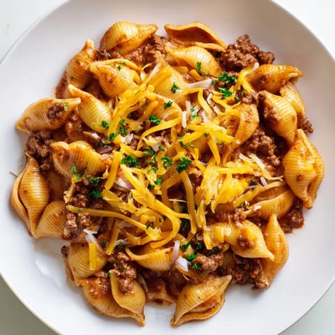 A comforting bowl of One Pot Creamy Beef and Shells, featuring tender pasta shells coated in a rich, creamy tomato sauce with savory ground beef.  