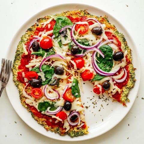 Golden-brown Broccoli Chicken Crust Pizza fresh from the oven, showcasing a crispy edge and colorful vegetable toppings.