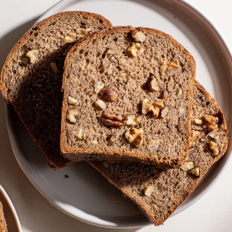 Golden crust of fresh-baked Nutty Whole Wheat Loaf Bread, perfect for sandwiches with delightful texture.