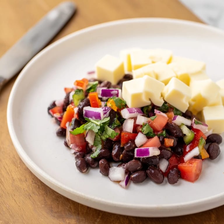 Fresh, spicy Pepper Jack cheese cubes with a bright, colorful black bean salsa, ready to serve.
