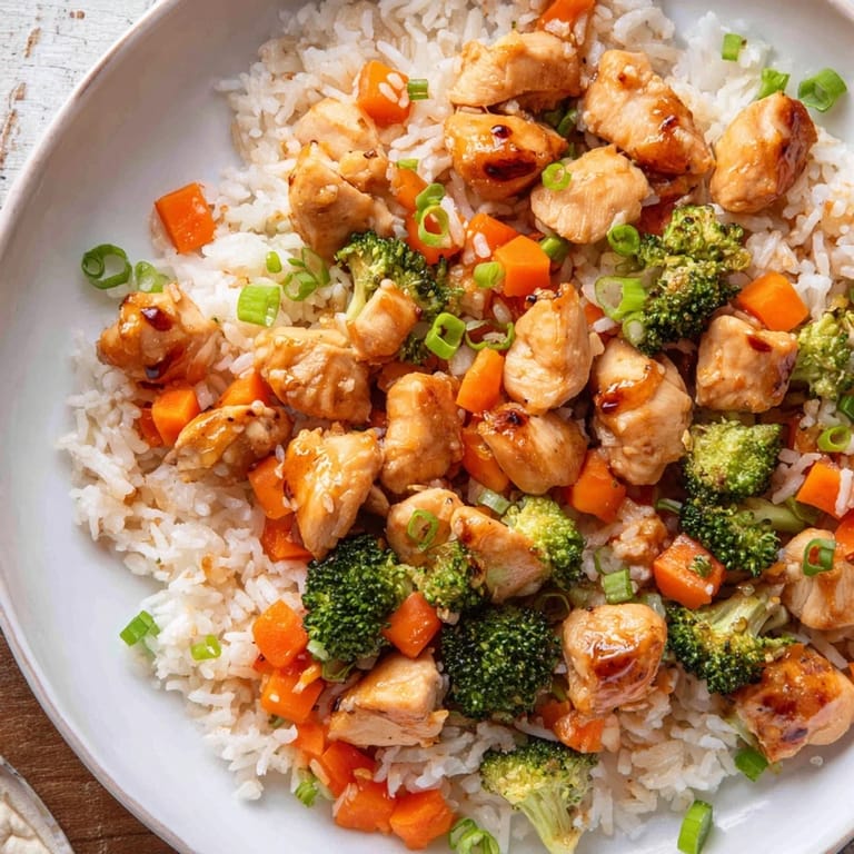 Served in a rustic bowl, the One Pan Honey Garlic Chicken Broccoli Rice combines savory chicken, fluffy rice, and steamed broccoli with a sweet garlic glaze.