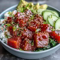 Vibrant Spring Tuna Poke Bowl with fresh tuna, crisp radish, cool cucumber, and ponzu sauce served over sushi rice. A colorful, refreshing seafood meal perfect for warm days.